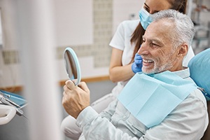 a patient smiling after receiving dental implants in Powell