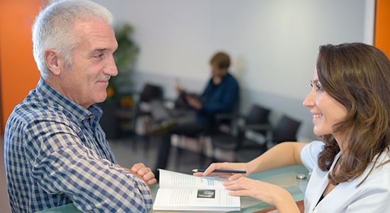 Dental patient reviewing dental insurance information with team member