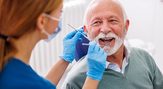 Man smiles at dentist