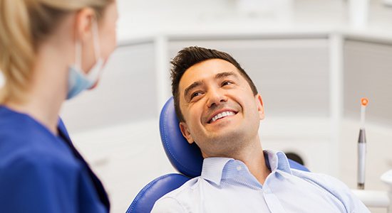 Man smiles at dentist