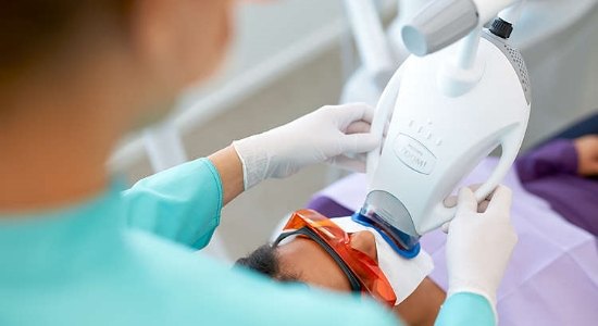 Patient receiving zoom in office teeth whitening