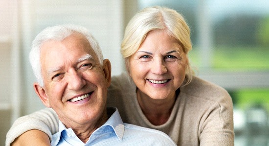 Older couple smiling at home