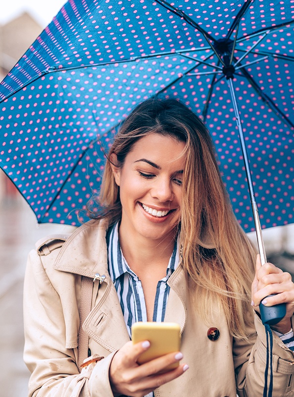 Smiling woman holding an umbrella