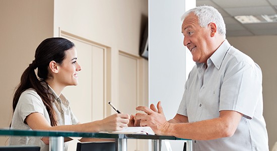 Dental patient discussing dental insurance coverage with a dental team member