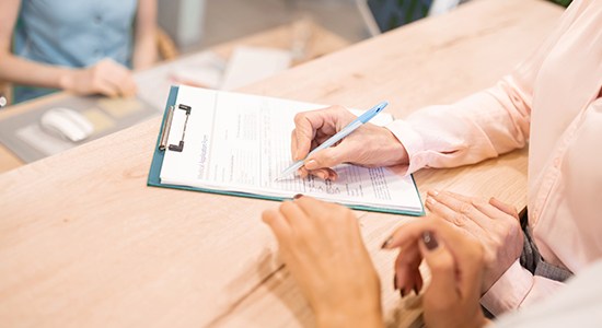 Patient completing dental insurance forms