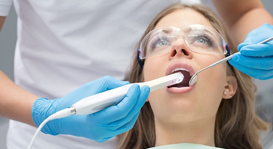 Dentist using intraoral camera to capture images