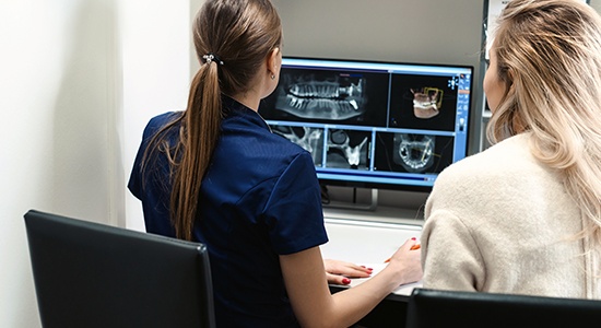 Dental team members reviewing series of digital x-rays