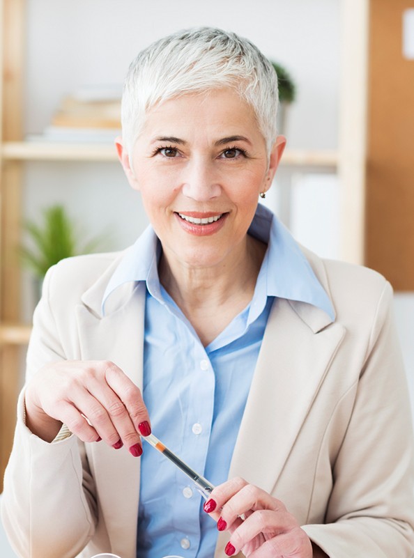 Woman with dentures sharing flawless smile