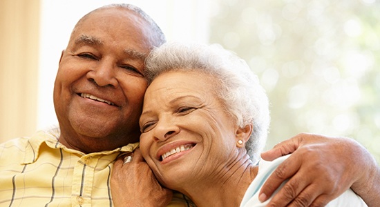 older couple smiling and relaxing at home