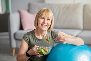 Healthy senior woman, smiling and eating nutritious foods