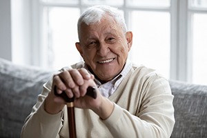 Senior man, enjoying long-term benefits of dental implants