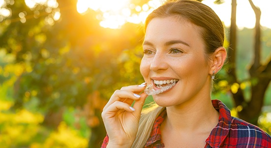 a patient holding their Invisalign aligner 