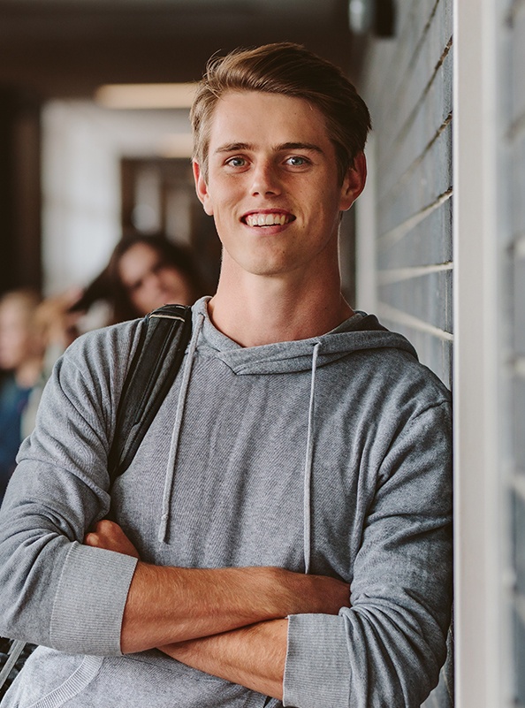 Young man sharing aligned smile after Invisalign clear braces treatment