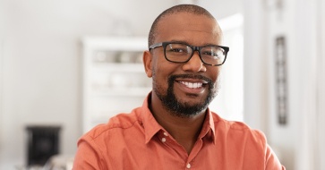 Man sharing attractive smile after replacing missing teeth