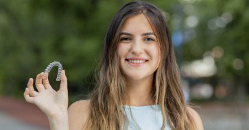 Young woman holding an invisalign tray