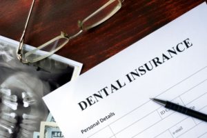 dental insurance form on dark wood table 