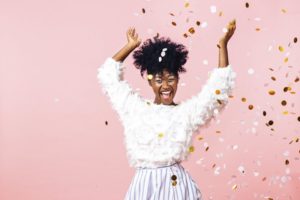 Woman throwing confetti to celebrate New Year's resolutions