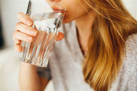 person drinking glass of water